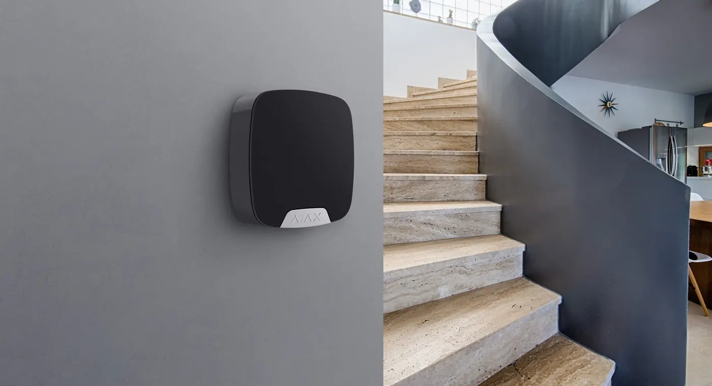 Ajax siren mounted on a wall in a modern home